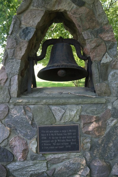 First school bell heritage sign at Heritage Garden