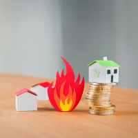 Three woof model homes sitting on a table surrounding a wood flame. 